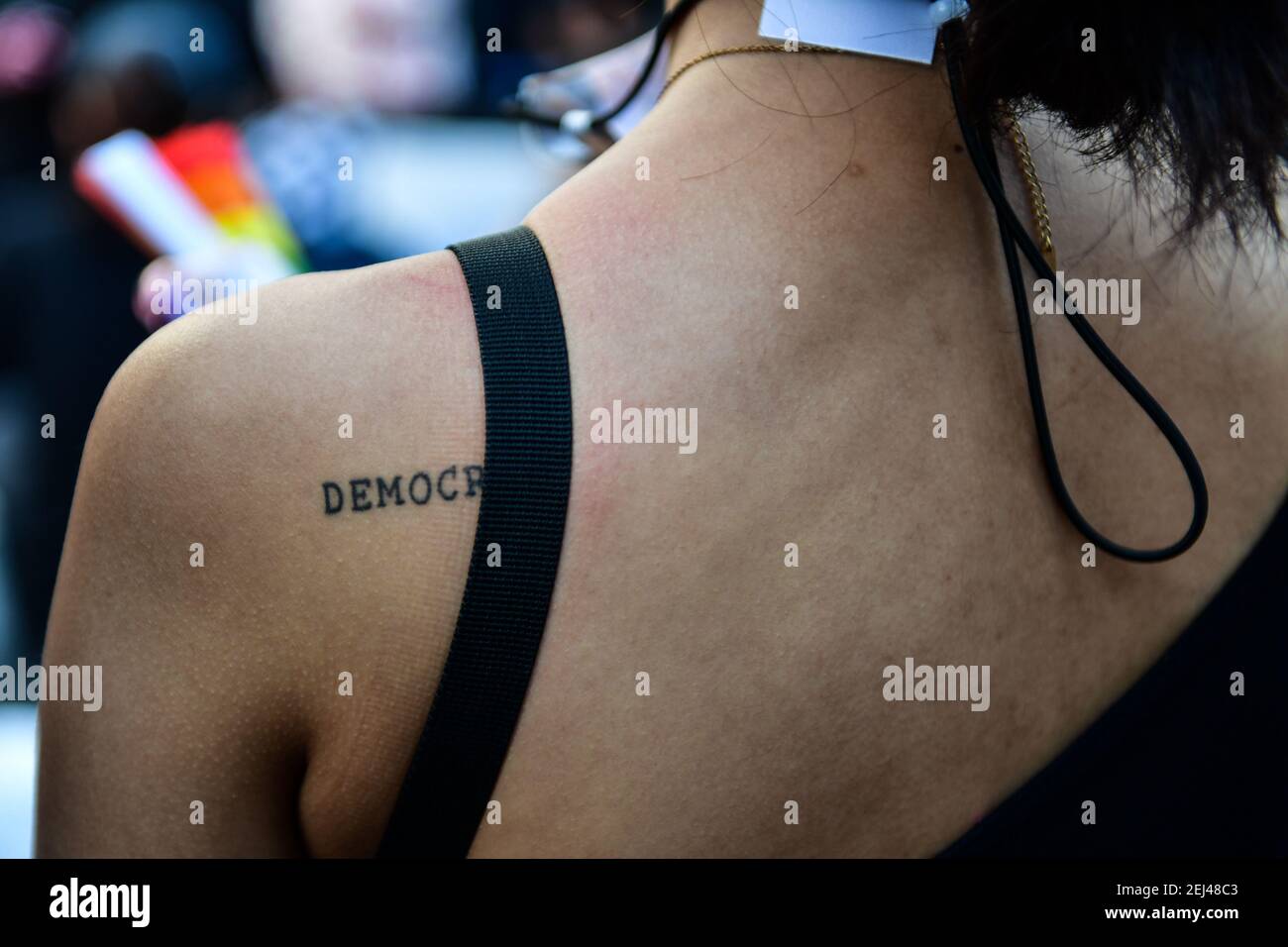 Thailand. 20th Feb, 2021. A protester with the tattooed the word DEMOCRACY on her back during protest in front of the Parliament in Bangkok Thailand, February 20, 2021. Anti-government protesters - including leaders who were charged with Lese Majeste offenses - amassed in Bangkok again in large numbers, as the Thai parliament voted on no-confidence motion in the government on Saturday. (Photo by Vichan Poti/Pacific Press/Sipa USA) Credit: Sipa USA/Alamy Live News Stock Photo
