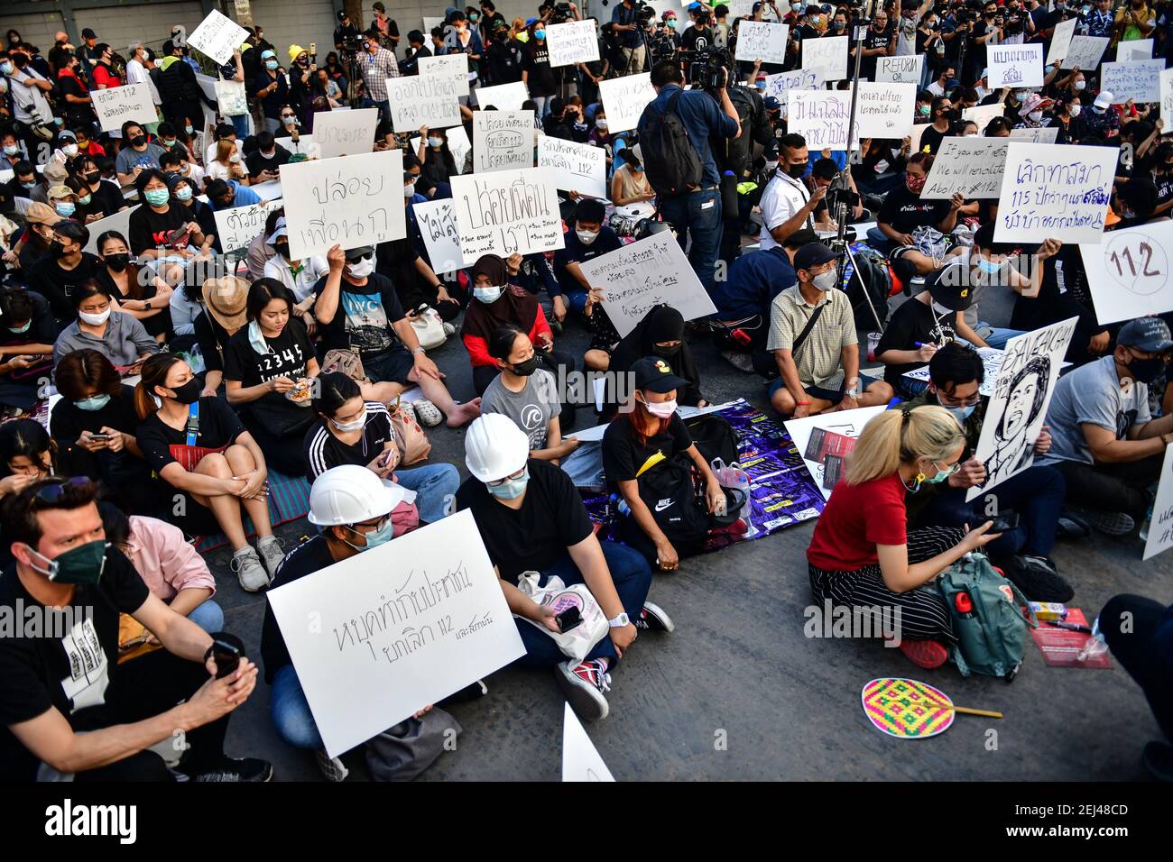 Thailand. 20th Feb, 2021. Pro-democracy protesters hold up the placards during protest in front of the Parliament in Bangkok Thailand, February 20, 2021. Anti-government protesters - including leaders who were charged with Lese Majeste offenses - amassed in Bangkok again in large numbers, as the Thai parliament voted on no-confidence motion in the government on Saturday. (Photo by Vichan Poti/Pacific Press/Sipa USA) Credit: Sipa USA/Alamy Live News Stock Photo