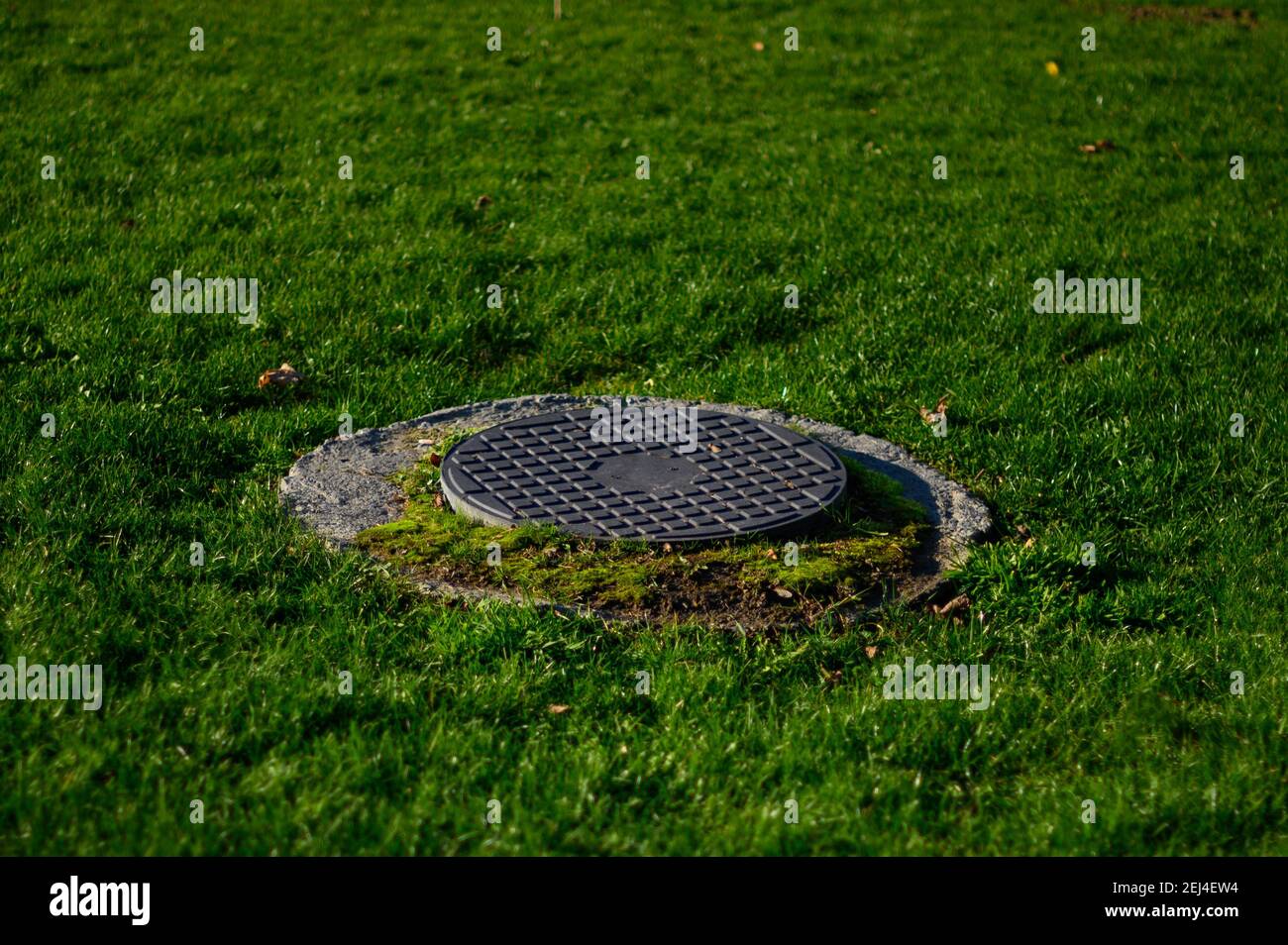 Sewer manholes in the city park, drainage system, reservoirs.2020 Stock Photo