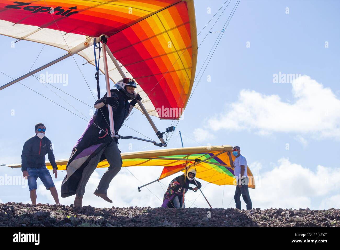 Las Palmas, Gran Canaria, Canary Islands, Spain. 21st February, 2021. Hang gliders taking off from cliffs over the Atlantic ocean on the rugged north coast of Gran Canaria. Credit: Alan Dawson/Alamy Live  News. Stock Photo