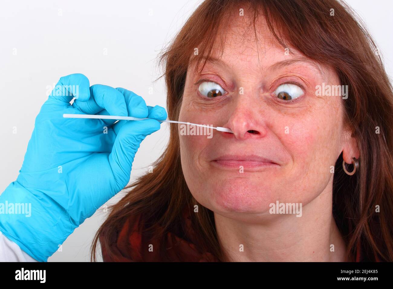 Covid 19 PCR rapid test, Corona, woman being tested nasopharyngeally, fun picture of self test Stock Photo