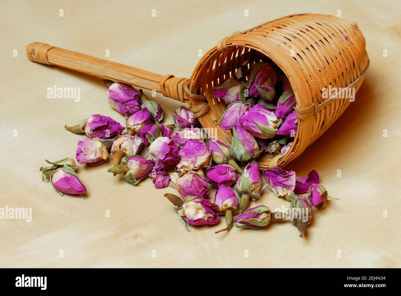 Dried rosebuds in bamboo tea strainer Stock Photo