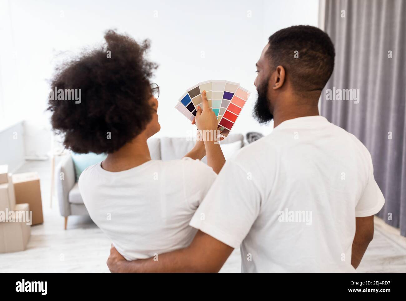 African Couple Planning Renovation Choosing Color For Walls Painting Indoor Stock Photo