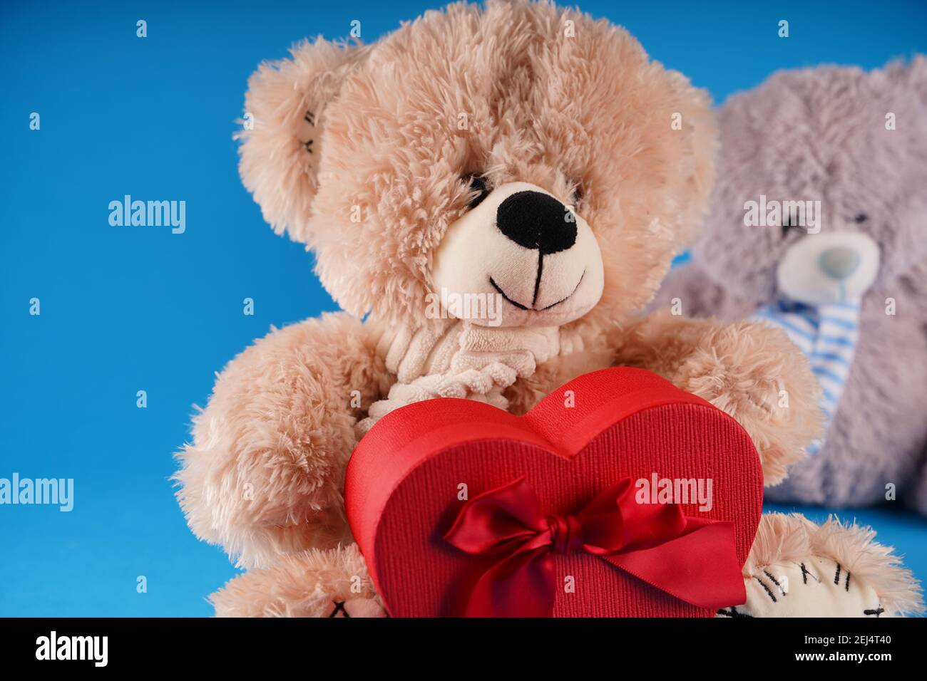 Close Up Of Cute Teddy Bears With Red Gift Box In Form Of Heart Soft Plush Toys With Present On Blue Background Concept Of Holidays Presents And Go Stock Photo Alamy