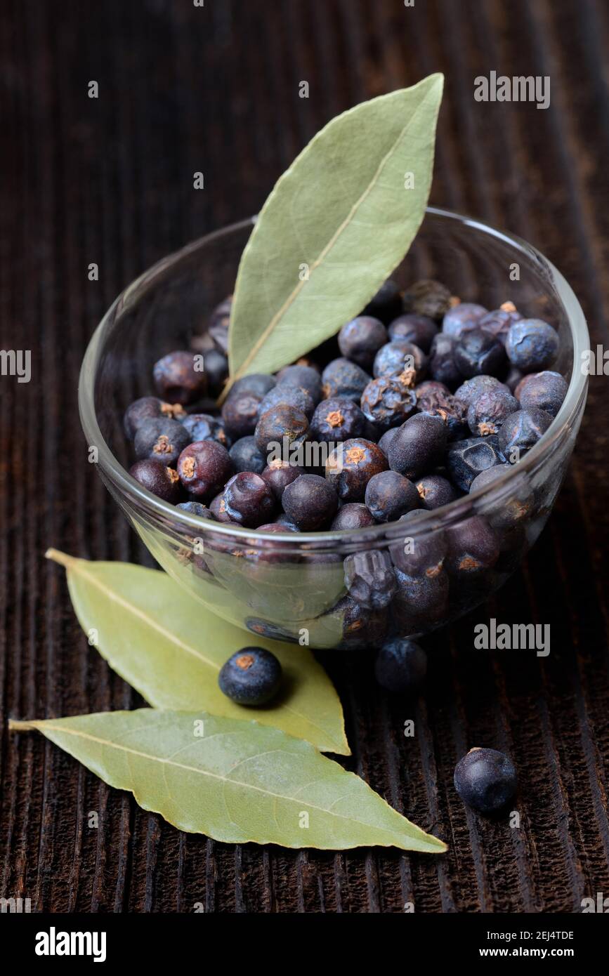 Dried juniper berries ( Juniperus communis) in brass ladle, dried bay