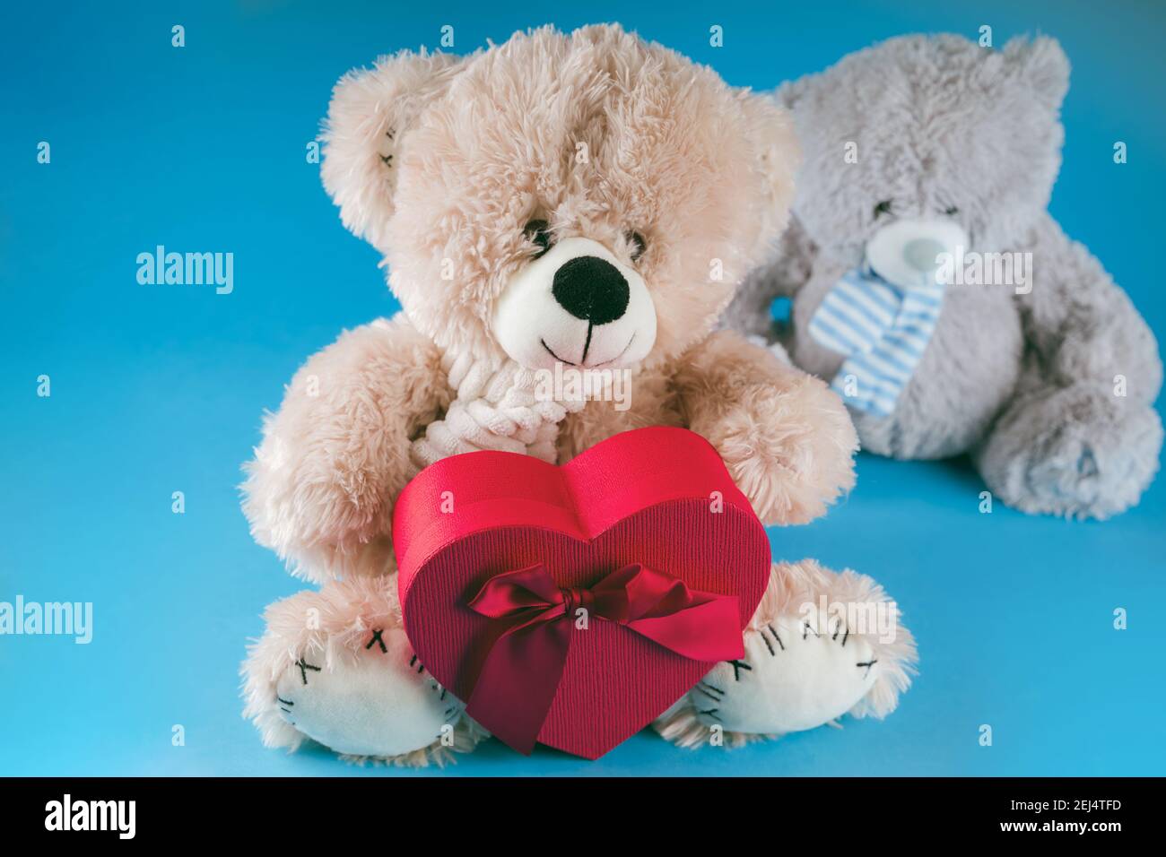 Close Up Of Cute Teddy Bears With Red Gift Box In Form Of Heart Soft Plush Toys With Present On Blue Background Concept Of Holidays Presents And Go Stock Photo Alamy