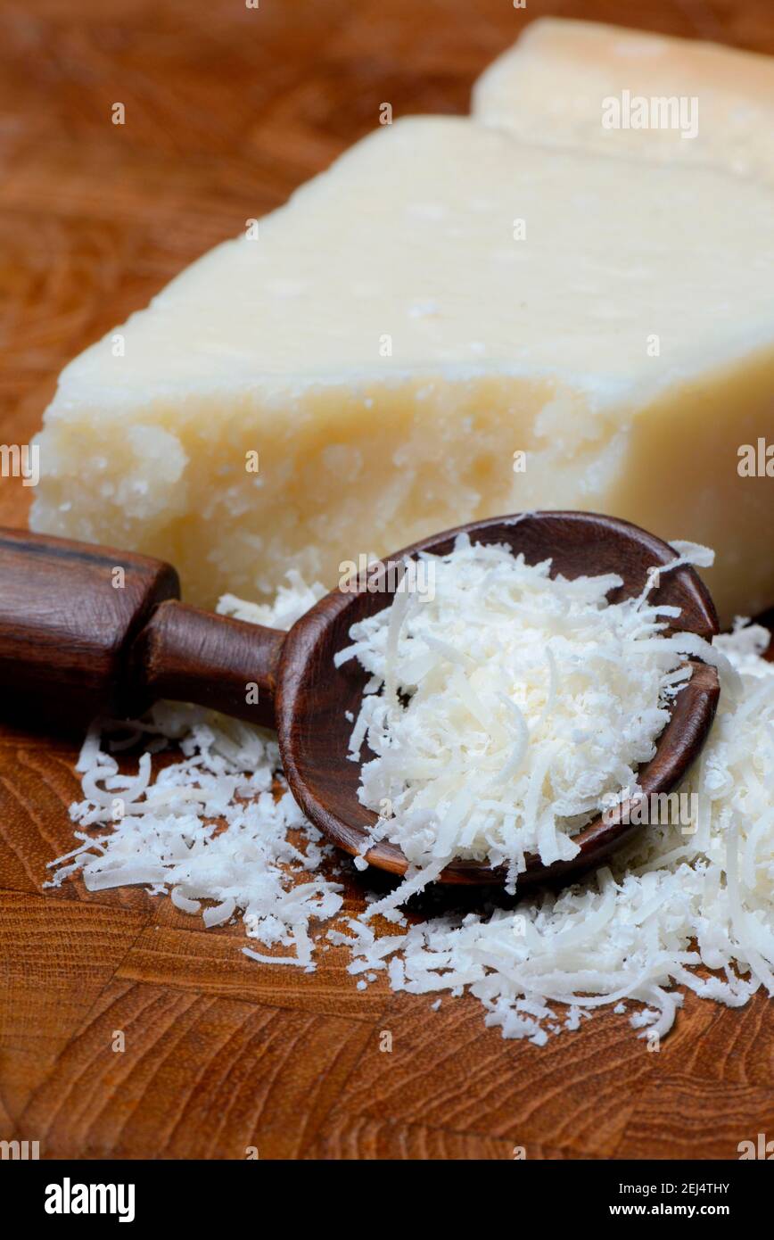 Grated Parmesan cheese and piece of Parmesan cheese, Parmigiano Reggiano Stock Photo Alamy