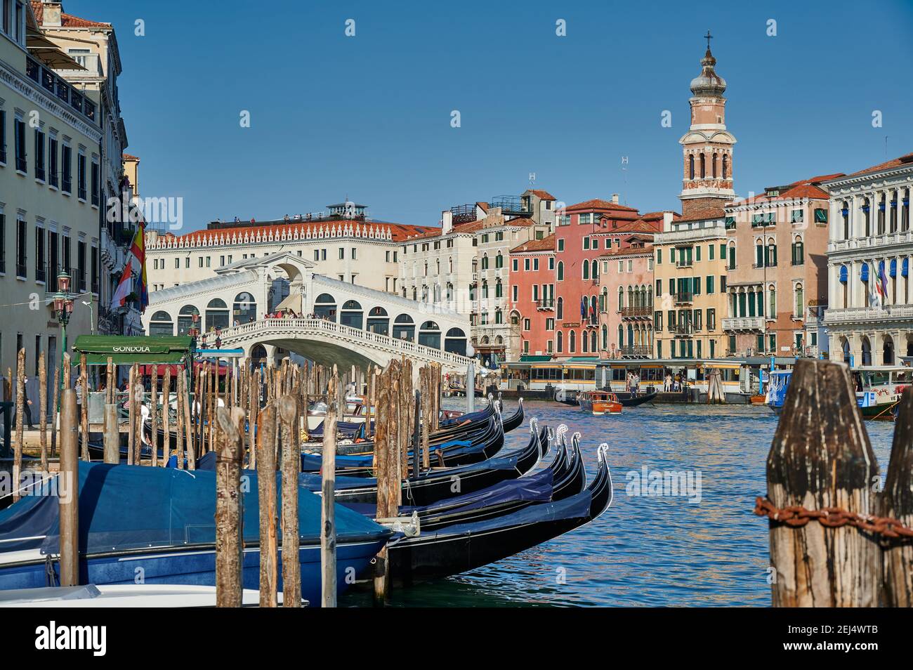 Rialto Bridge seen from boat with gondulas in front, Venice, Veneto, Italy Stock Photo