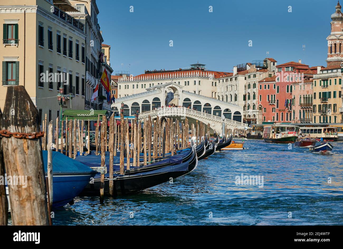 Rialto Bridge seen from boat with gondulas in front, Venice, Veneto, Italy Stock Photo