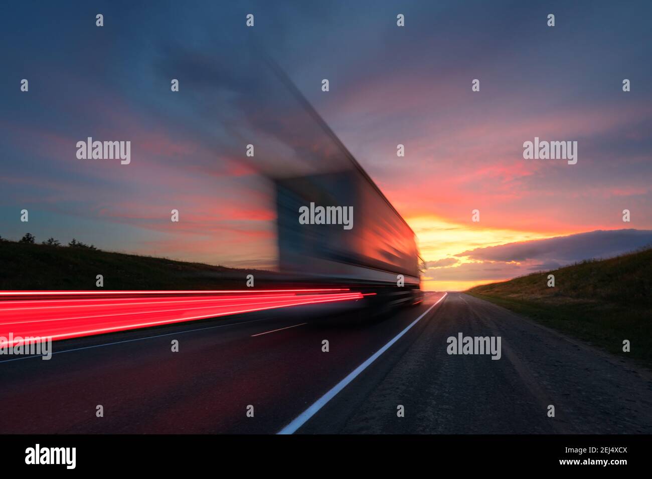 Blurring. A large truck is driving along the highway at high speed. Sky ...