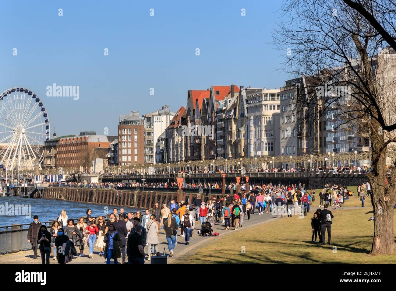 Düsseldorf, NRW, 2021. People enjoy their Sunday afternoon in beautiful warm sunshine with temperatures up to 18 degrees, strolling along the River Rhine in Düsseldorf, the capital of Germany's most populous state of North Rhine-Westphalia. Credit: Imageplotter/Alamy Live News Stock Photo