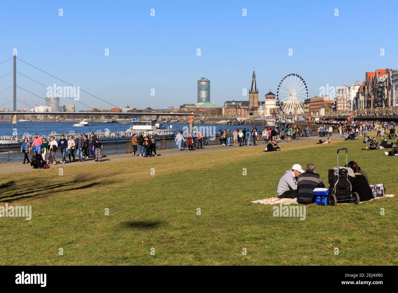 Düsseldorf, NRW, 2021. People enjoy their Sunday afternoon in beautiful warm sunshine with temperatures up to 18 degrees, strolling along the River Rhine in Düsseldorf, the capital of Germany's most populous state of North Rhine-Westphalia. Credit: Imageplotter/Alamy Live News Stock Photo