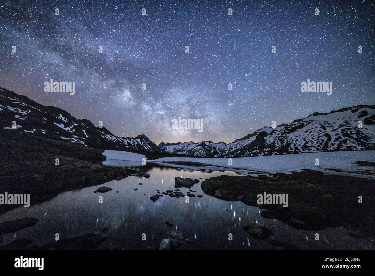 Maladeta range and the Aneto peak at night with the Milky Way. in the sky. Viewed from the other side of the valley, near to Port de Benasque (Spain) Stock Photo