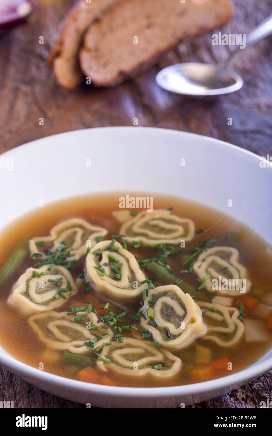 bavarian maultasche soup on wood Stock Photo
