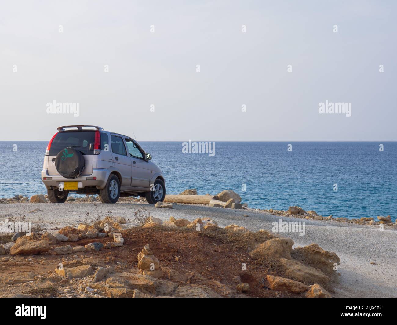 Off-roader jeep standing and resting on a lonely shore of calm mediterranean sea in Ayia Napa, Cyprus. Marine view. Stock Photo