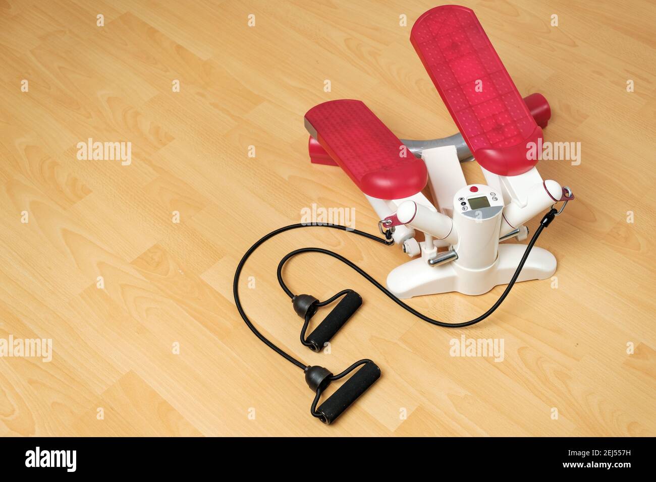 Fitness stepper or cardio training with digital display on the floor. Workout at home during pandemic and quarantine. Keep fit. Home gym equipment Stock Photo