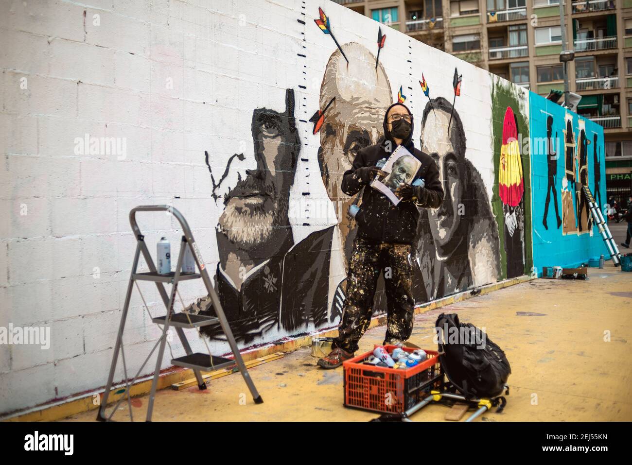 Barcelona, Spain. 21st Feb, 2021. A street artist paints graffiti criticizing Spain's monarchy in support of imprisoned rap artist Pablo Hasel. convicted to jail for glorifying terrorism and insulting Spain's former king in lyrics, after five nights of riots. Credit: Matthias Oesterle/Alamy Live News Stock Photo