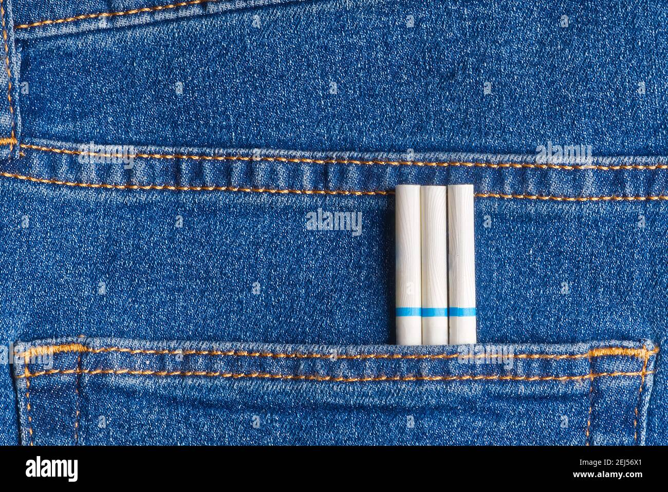 slim cigarettes in the jeans pocket on back side Stock Photo