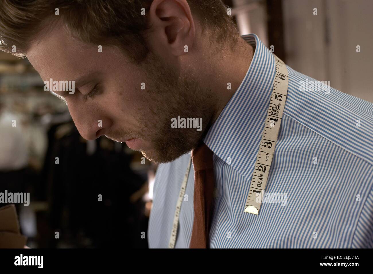 tailor with measuring tape at Savile Row, London, UK Stock Photo