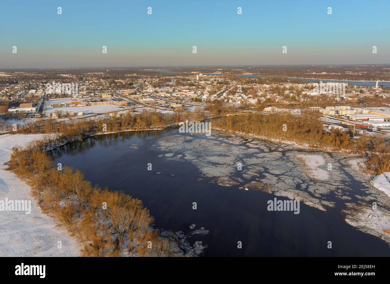 Aerial view of a winter in suburb city with snow covered of Burlington, NJ residential quarters by the Delaware river the American town on after snowfall USA Stock Photo