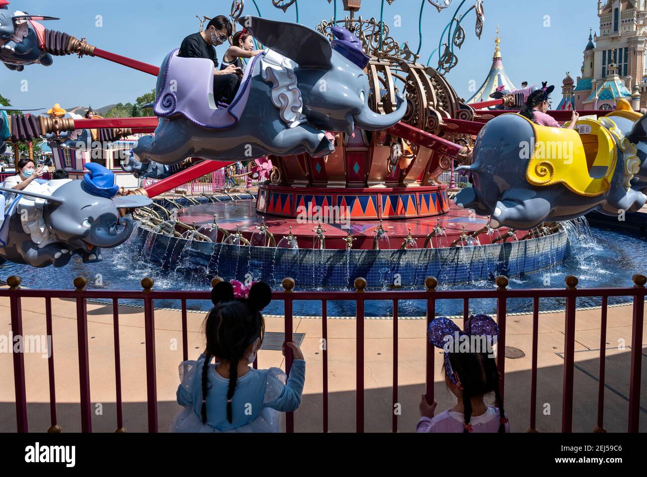 Two young girls line up for the ride of Dumbo the Flying Elephant while