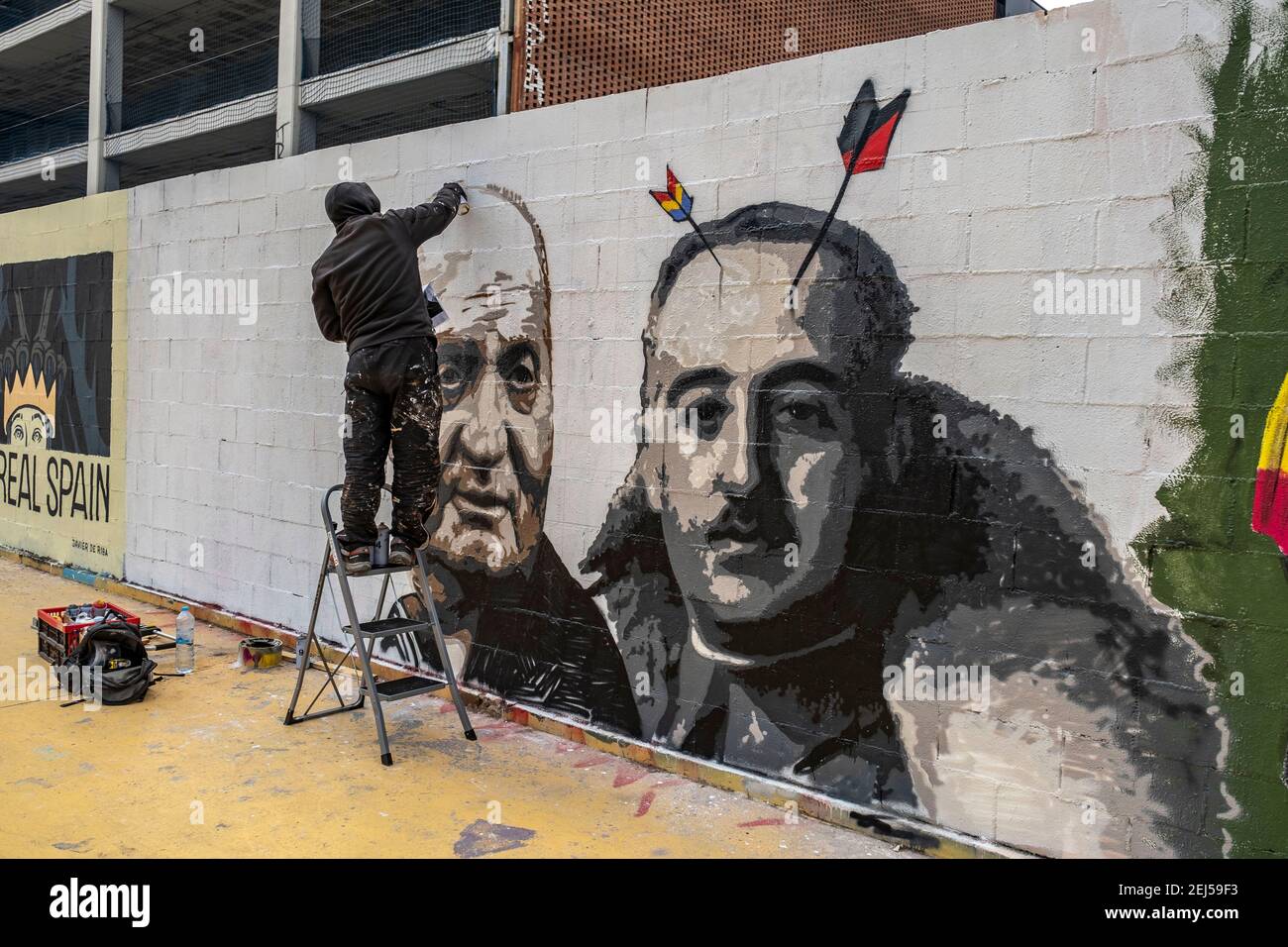 The graffiti artist Rock Black Block is seen in Les tres Ximeneies square  working on a new mural that relates the Spanish monarchy with the Franco  dictatorship.Graffiti day for freedom of expression