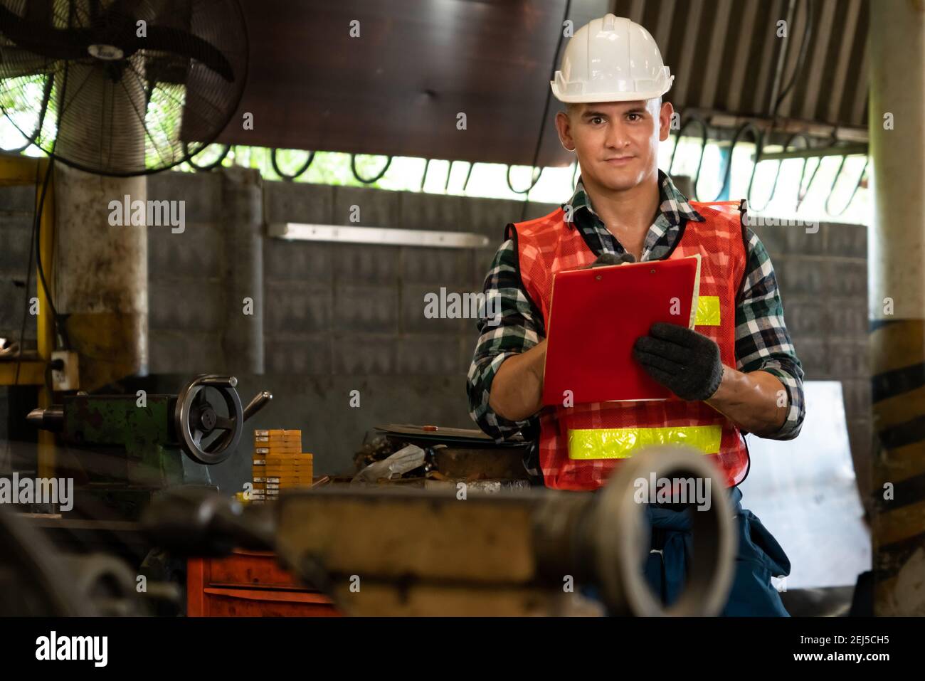 Manufacturing worker working with clipboard to do job procedure