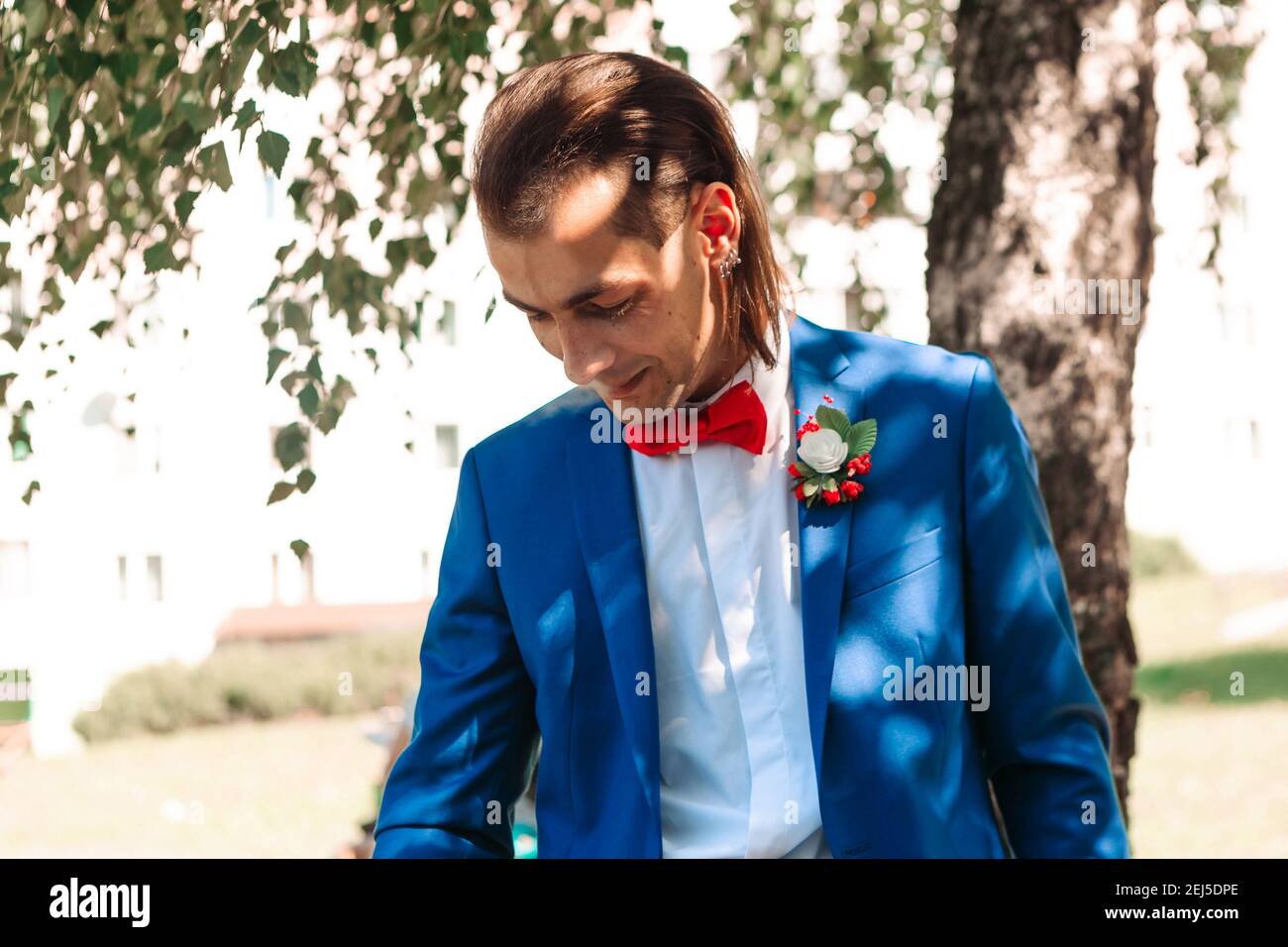 Portrait Of Young Handsome Man In Blue Suit With Red Bow Tie. Wedding  Concept Stock Photo - Alamy