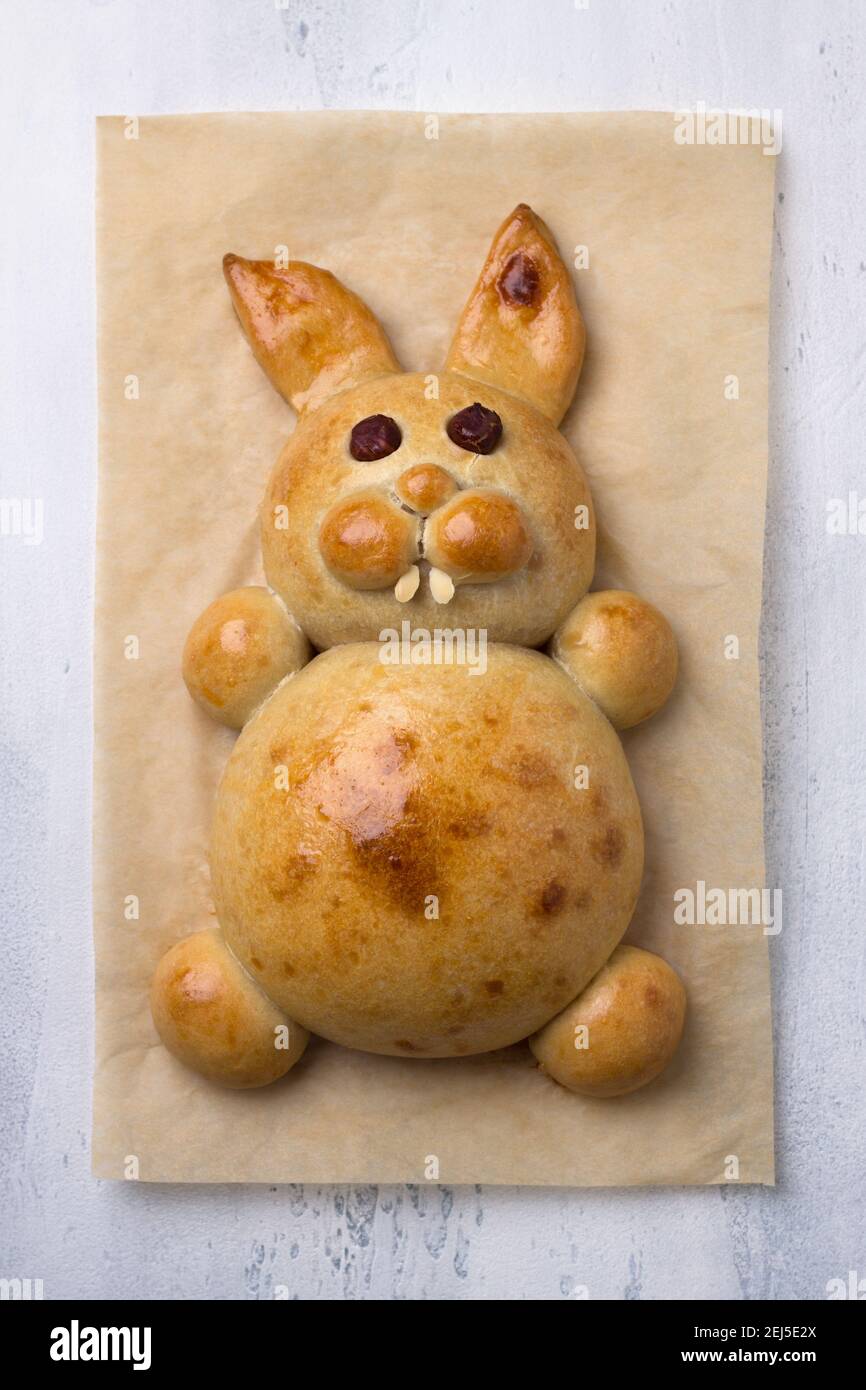 A process of making Easter Bunny Buns of delicious sweet dough. Do it yourself. Step by step instruction. Step 5. Bake the Easter Bunny Bun. Happy eas Stock Photo