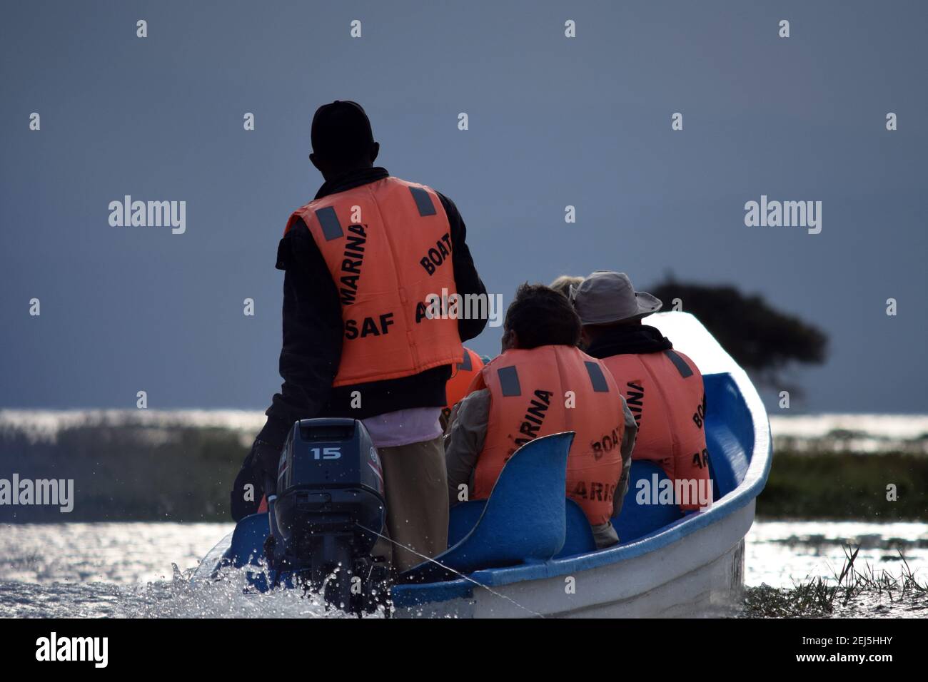 Tourist in a motorboat navigating a lake in Kenya Stock Photo Alamy