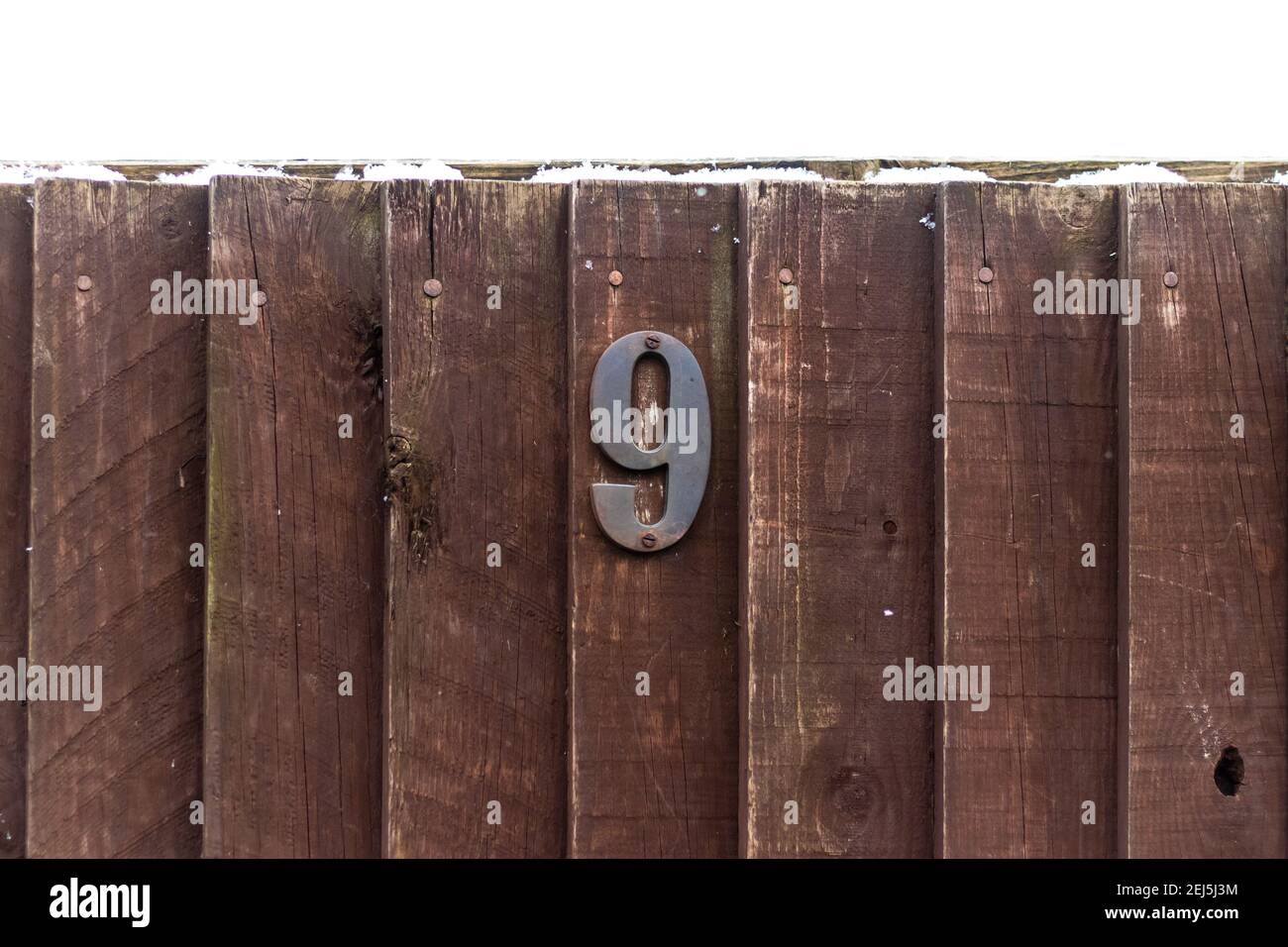 House number on a rough wooden fence Stock Photo Alamy