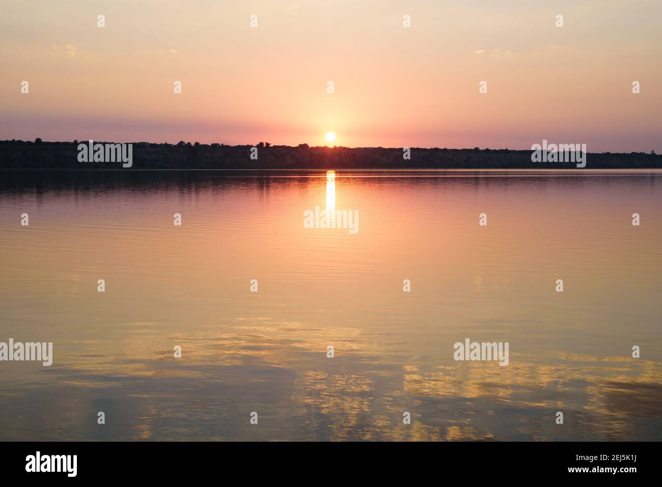 Summer landscape with reflection of colorful sunset in the lake Stock Photo