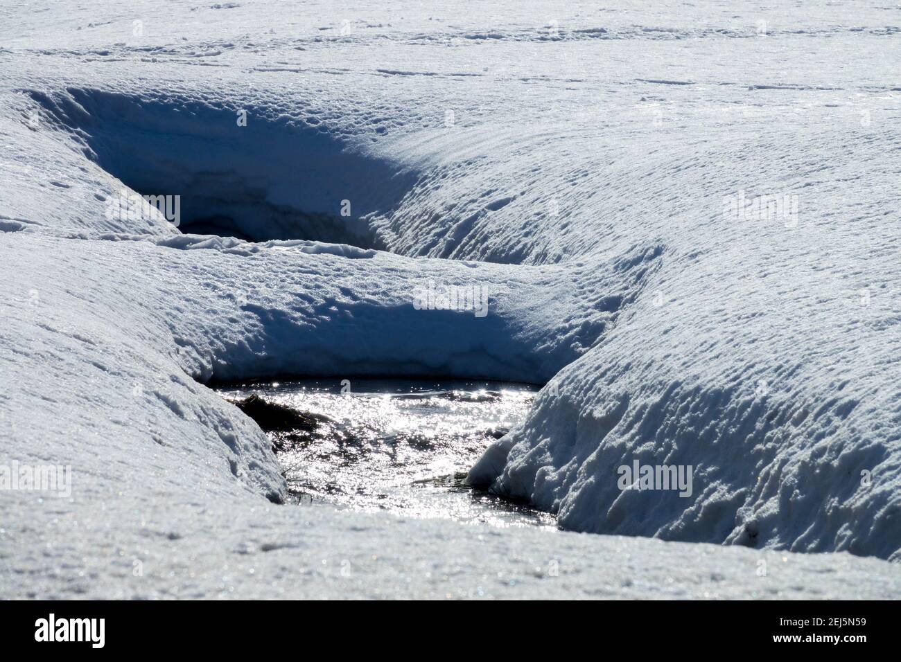 Thawing snow and runoff of melting water in the forming stream bed, melting stream Czech Republic Stock Photo