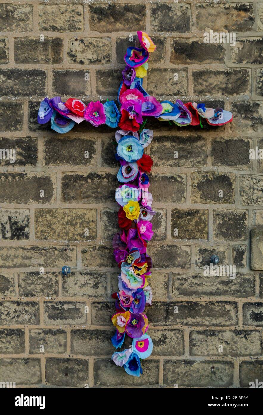 An Easter Christian Cross made out of paper flowers. Stock Photo