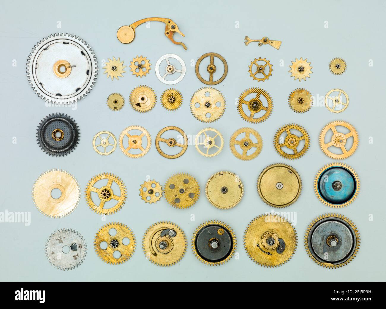 Vintage gears and cogs on light blue background. Stock Photo