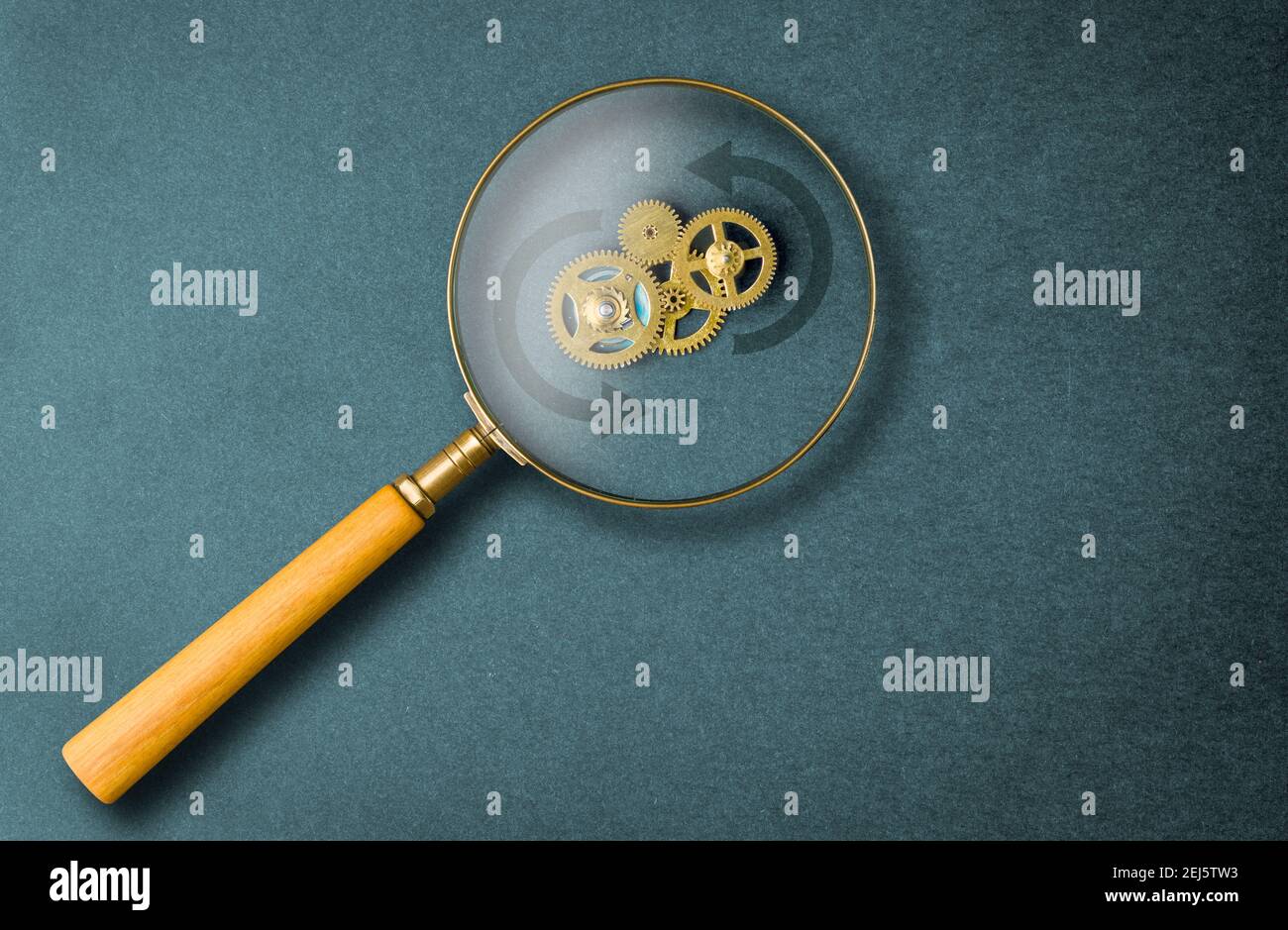 Concept, search mechanism. Illustrated by a gear mechanism seen thru a magnifier. Stock Photo