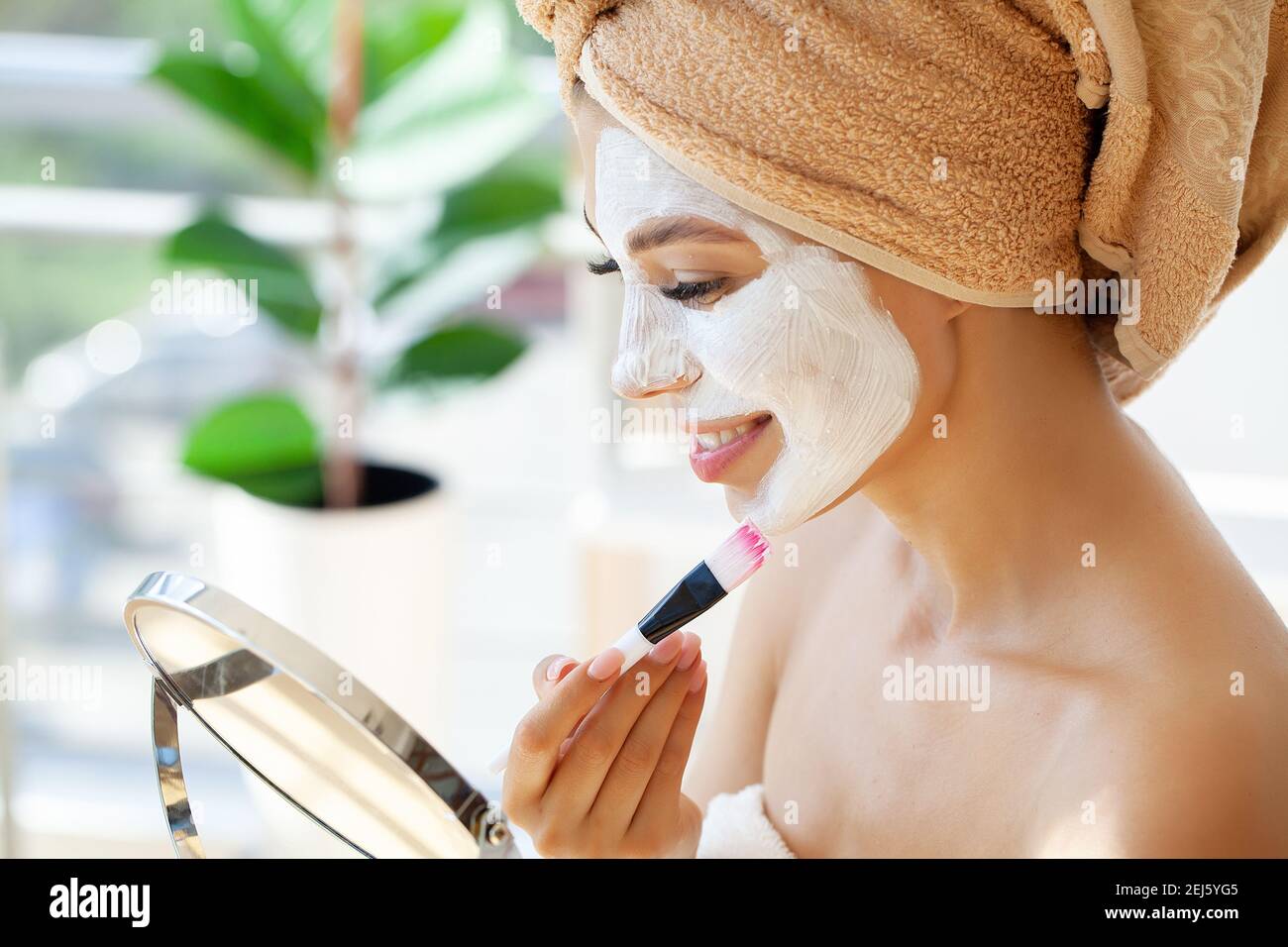 Skin care, woman with beautiful facial skin applying mask on face Stock ...