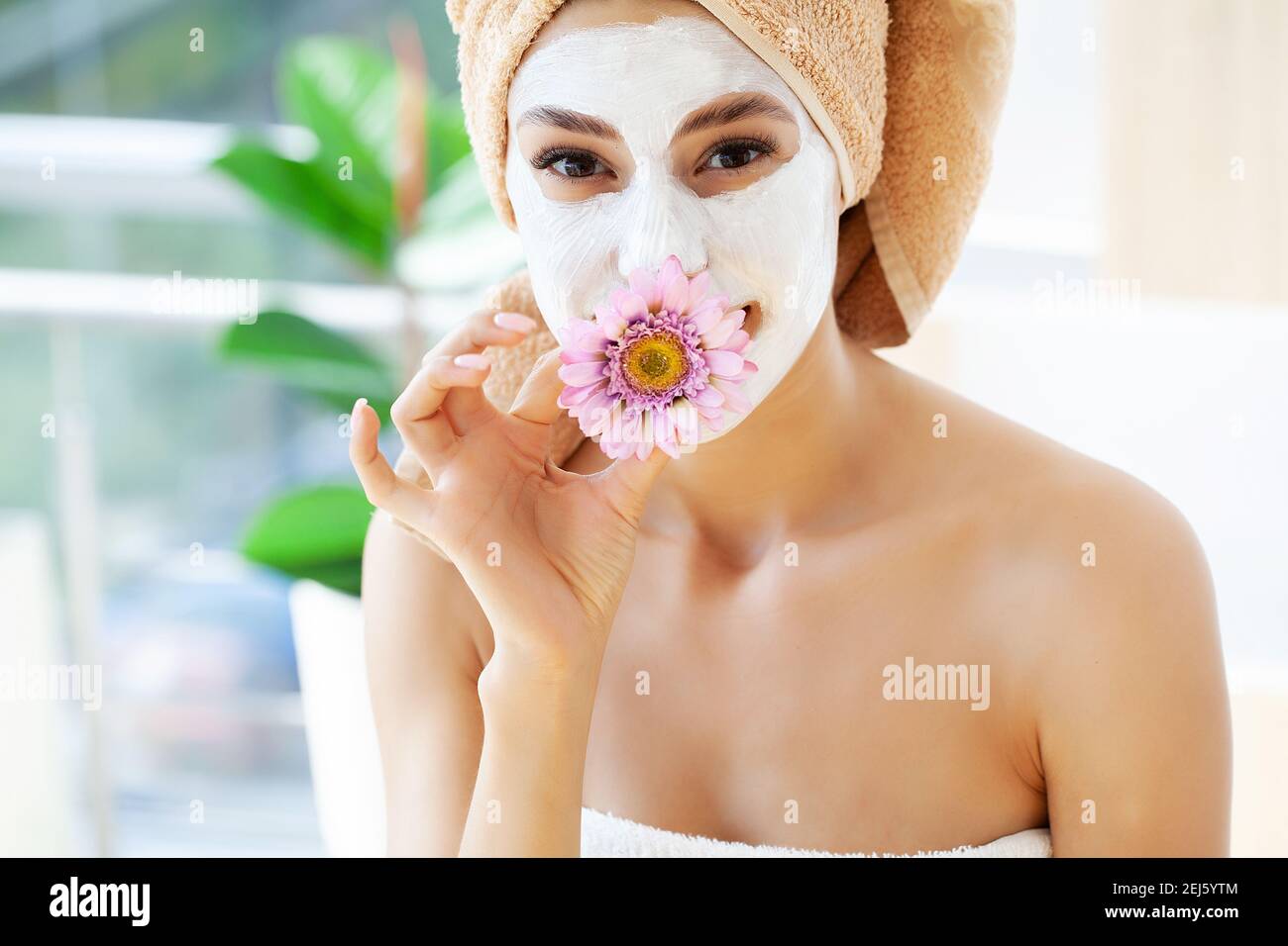 Attractive funny woman with a clay mask on her face Stock Photo - Alamy