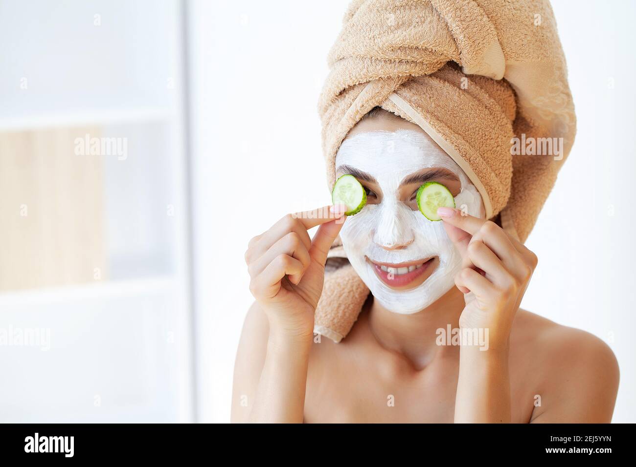 Skin care, woman with beautiful facial skin applying mask on face Stock ...