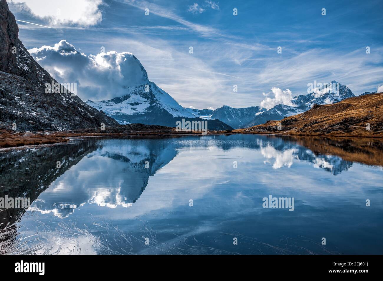 Panoramic view of Matterhorn peak, Switzerland. Matterhorn reflection in the Riffelsee. Stock Photo