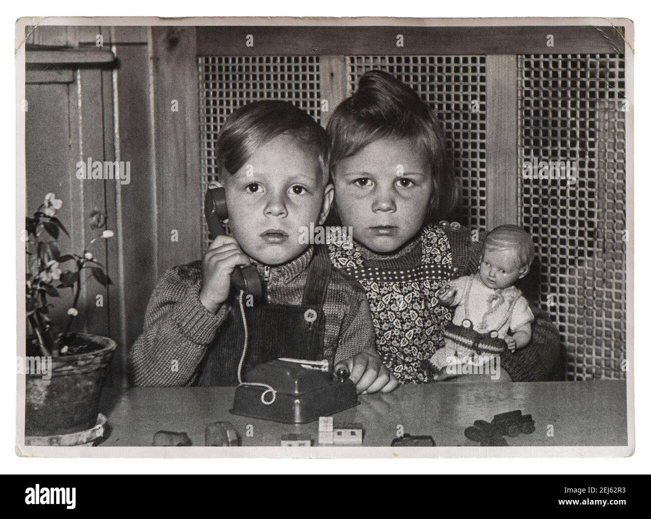Cute kids with toys. Vintage black white picture original film grain Stock Photo