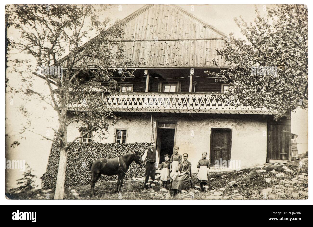 Vintage photo farmer family with horse in front of house. Country life style Stock Photo