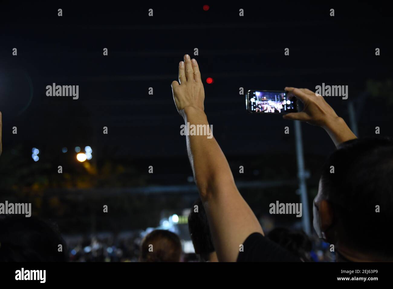Bangkok, Thailand. 20th Feb, 2021. The protester raised three fingers. As a symbol of resistance to the government Outside the New Parliament of Bangkok on Saturday, February 20, 2021. (Photo by Teera Noisakran/Pacific Press) Credit: Pacific Press Media Production Corp./Alamy Live News Stock Photo