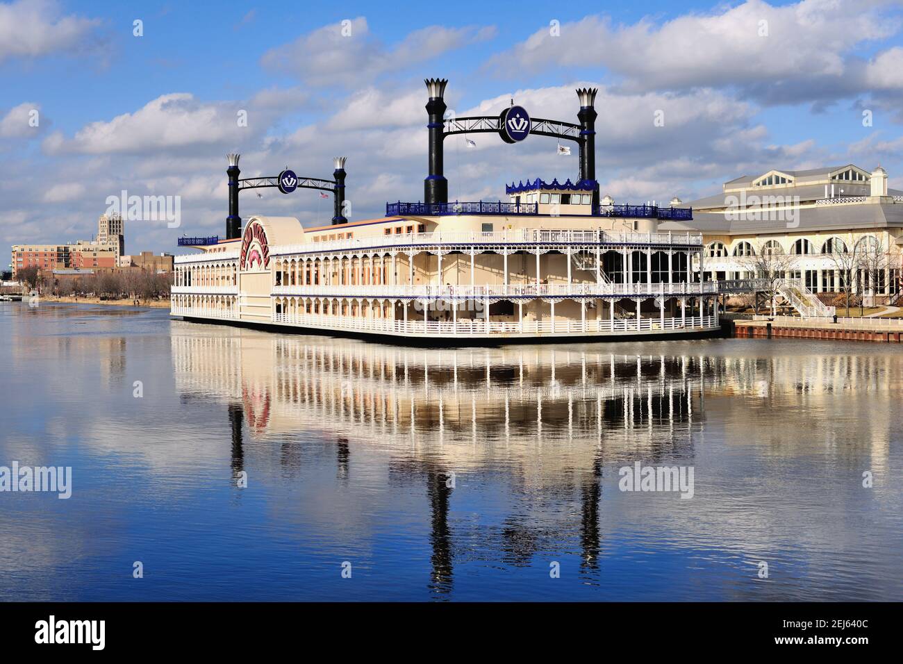 The Grand Victoria Casino and its riverboat reflecting into the Fox River in Elgin, Illinois. In the background, also reflecting into the river, is th Stock Photo