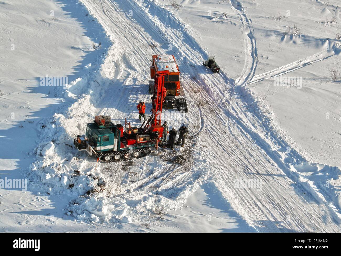 Geotech drilling rig testing gravel sources for the Inuvik-Tuktoyaktuk Highway during winter construction, Northwest Territories, Canada's Arctic. Stock Photo