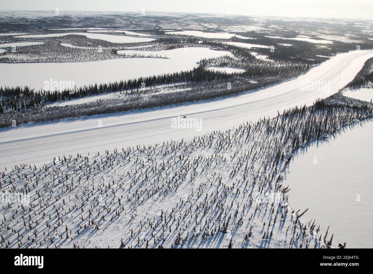 Aerial view of vehicle driving the Mackenzie River ice road in winter, in the Beaufort Delta, Northwest Territories, Canada's western Arctic. Stock Photo