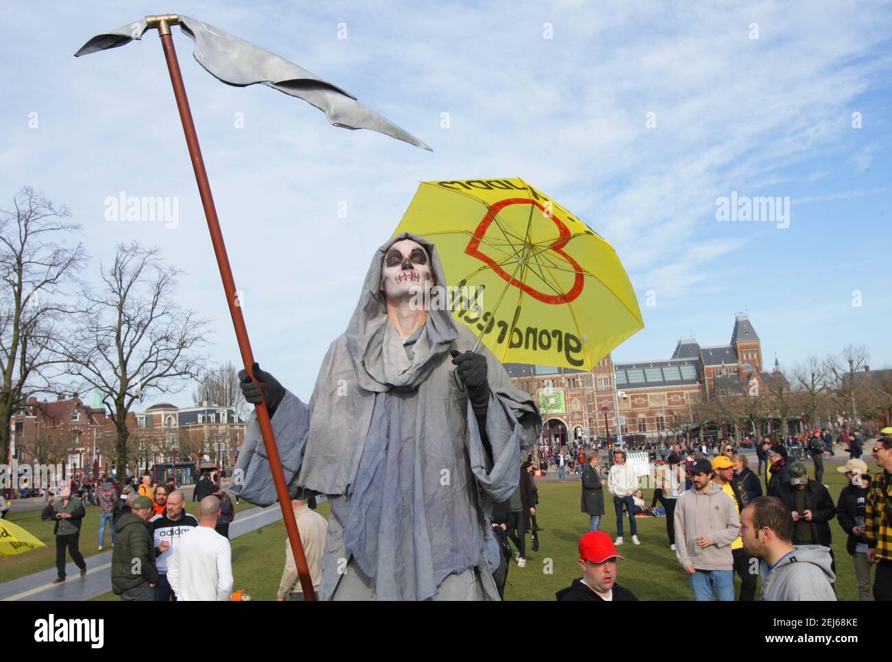 Anti-lockdown protester dressed as the grim reaper hold an umbrella “Freedom” during an illegal demonstration against coronavirus measures at the Muae Stock Photo