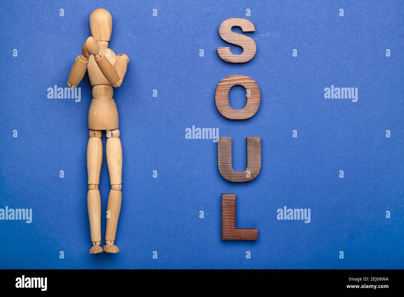 Wooden mannequin with word SOUL on color background Stock Photo