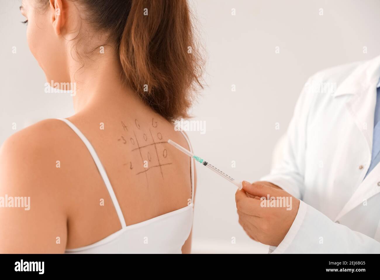 Patch tests stuck on the back of a woman, Tests for skin allergens