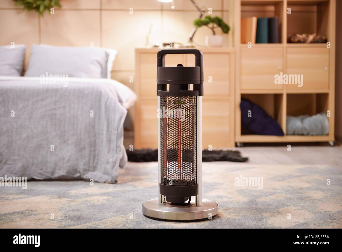 Modern electric heater in stylish bedroom Stock Photo Alamy